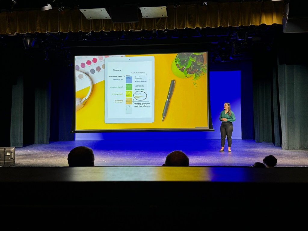 Karina presenting Naranote on a main stage in the three minute thesis competition.